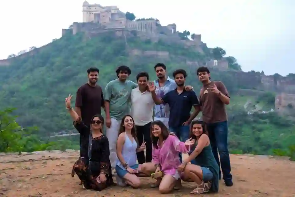 The group in front of a hilltop fort at dusk