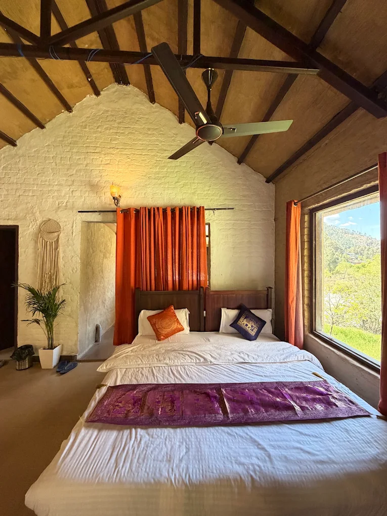 Double room with a large window overlooking the valley