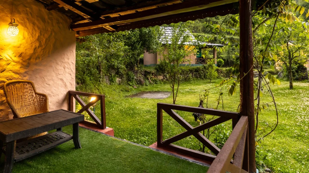 Covered cottage verandah facing a green garden
