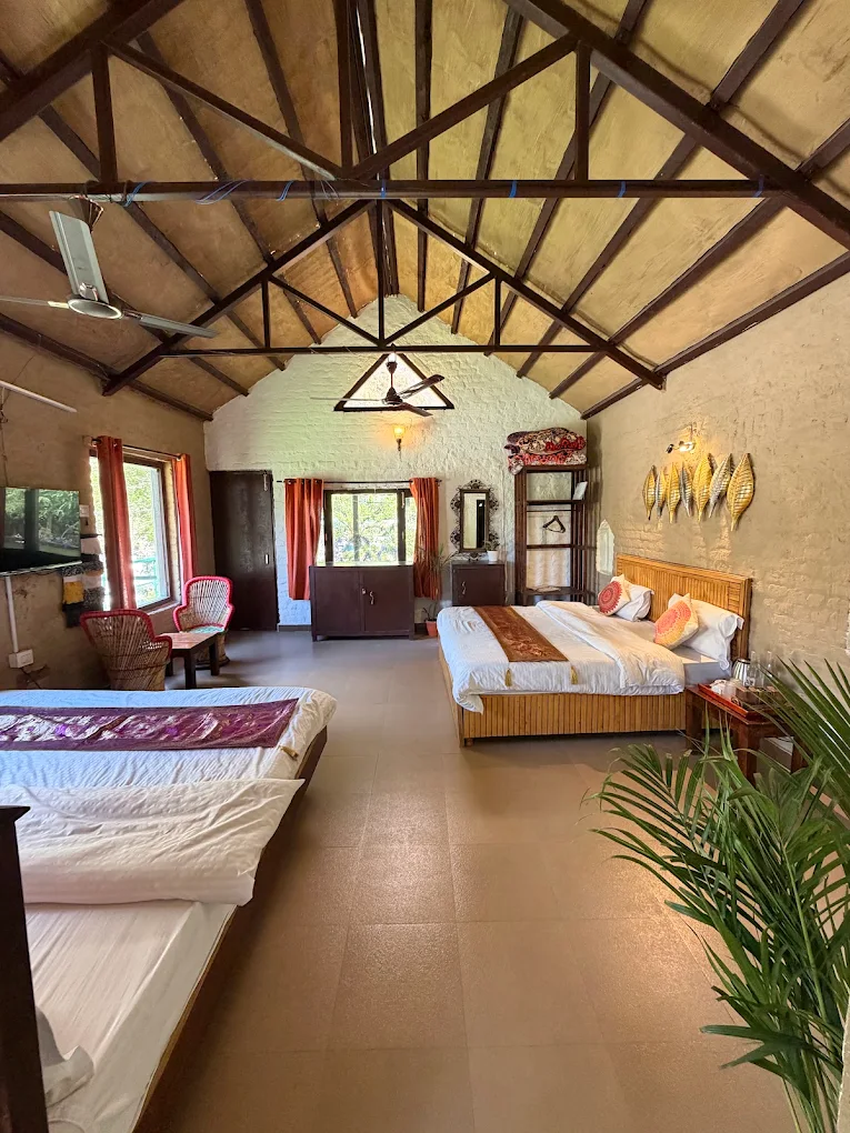 Spacious cottage room with three beds and a vaulted roof