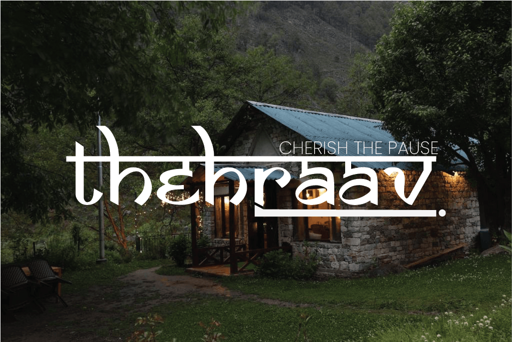 Theraav stone cottage surrounded by trees at dusk